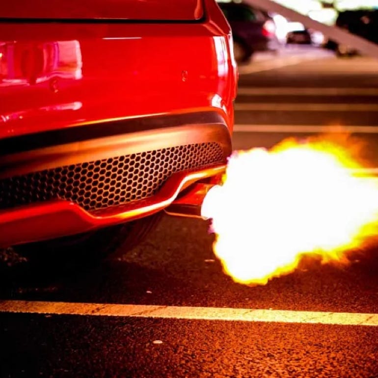 Red car backfiring with flames